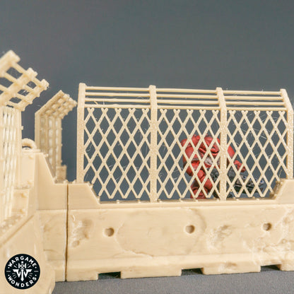 Beton‑Barrikaden mit Gitterzaun